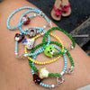 Green dog charm and green cats eye bracelet with toggle heart