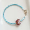 Flower bouquet glass charm and blue cat's eye bead bracelet with silver heart toggle bracelet