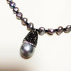 Pave crystals & Pearl drop on a strand of iridescent grey freshwater pearls and onyx necklace